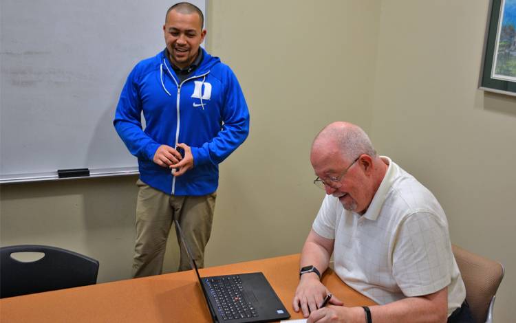 Jay Gallman, right, takes notes during a meeting with John Shaw. Photo by Jonathan Black.