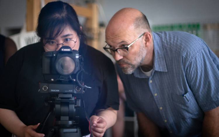 Jim Haverkamp, rights, helps Mara Guevarra, digital marketing and projects manager for Duke's Center for Documentary Studies, film during a class at CDS. Photo courtesy of Jim Haverkamp. Jim Haverkamp, right, helps Mara Guevarra, digital marketing and pro