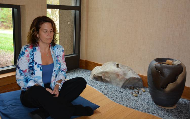 Jocelyn Weiss meditates in one of Duke Integrative Medicine's meditation rooms. Photo by Jonathan Black.