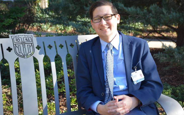 Jon Bae soaks up sunshine on Abele Quad. Photo by Jonathan Black.