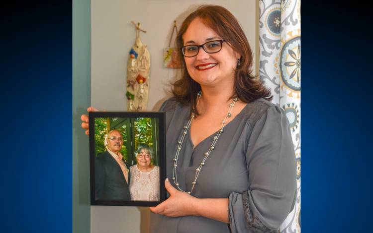 Katherine Ortiz holds a portrait of her parents. Photo courtesy of Katherine Ortiz.