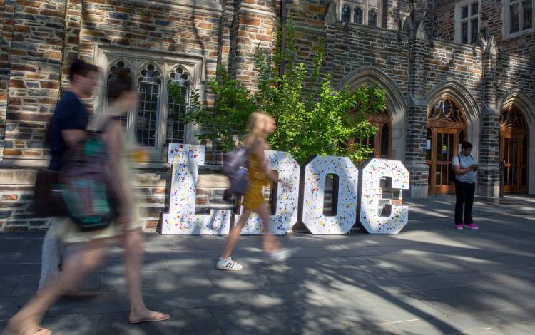 Students walk by an LDOC display.