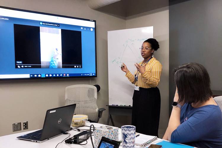 Lamercie Saint-Hilaire discusses her presentation topic with other members of the planning group. (Photo: Kathy Neal) 