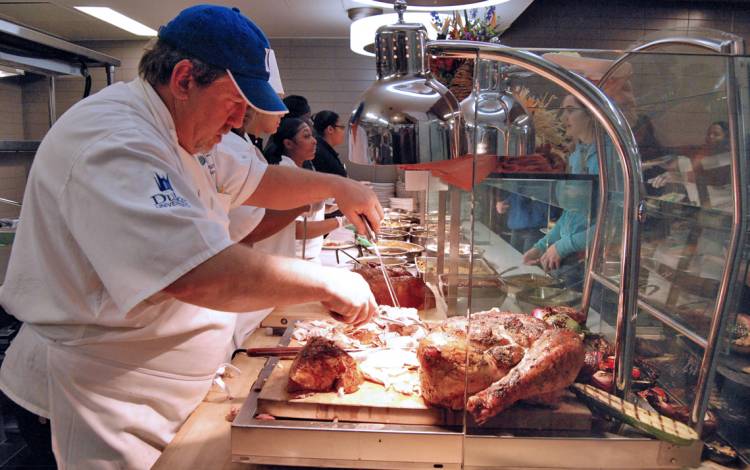 Executive Sous Chef Todd Dumke serves turkey during last month's Thanksgiving meal. Photo by Stephen Schramm.