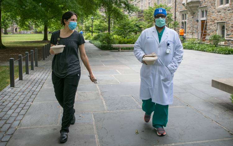 Duke employees wear masks on campus.