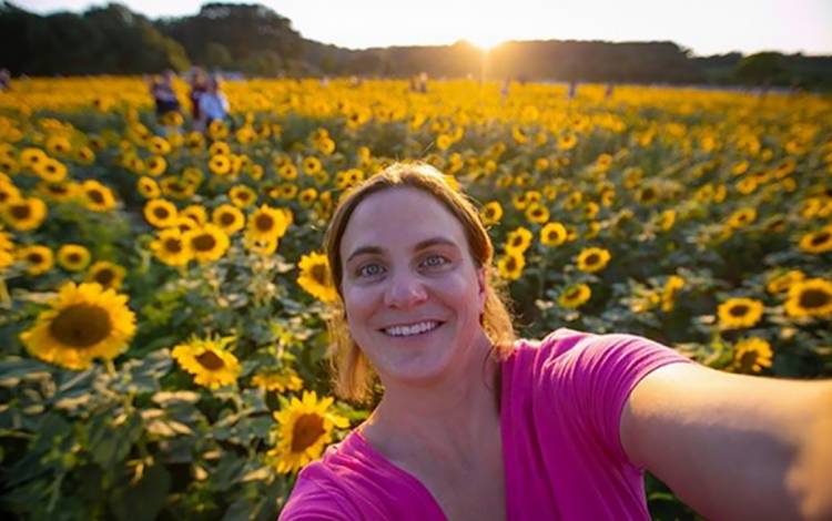 Megan Mendenhall in a field of sunflowers.