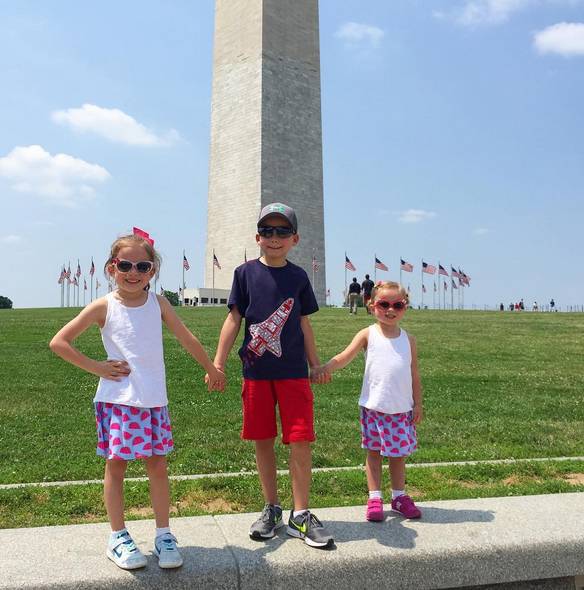 Melissa Hill's children pose in front of the Washington Monument.