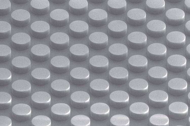 A dimpled surface with cylinders like the face of a Lego brick forms a non-metallic conductive material. The metamaterial absorbs electromagnetic energy without heating.