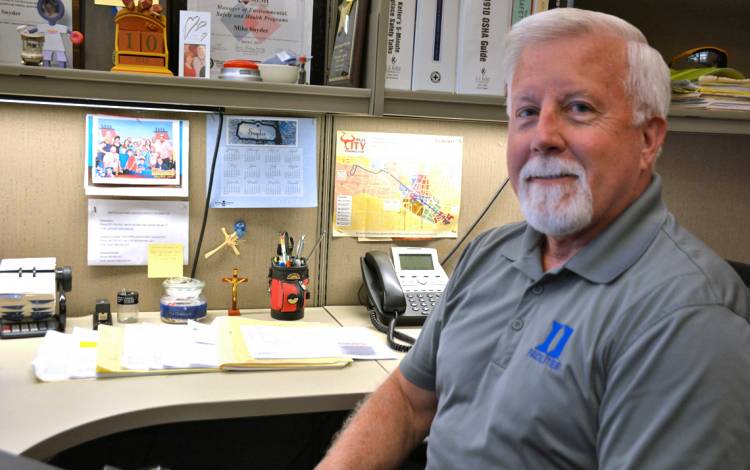 Mike Snyder organizes his desk before leaving work each day. Photo by Jonathan Black.