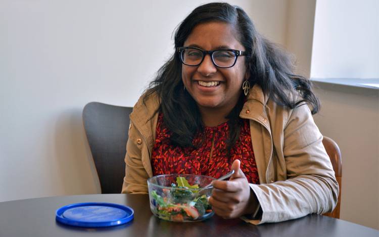 Minoka Gunesekera steps away from her desk to enjoy a salad during the later afternoon. Photo by Jonathan Black.