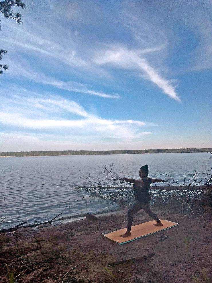 Monica Meza does sunrise yoga during a camping trip on the shores of Jordan Lake over the summer. Photo courtesy of Monica Meza.