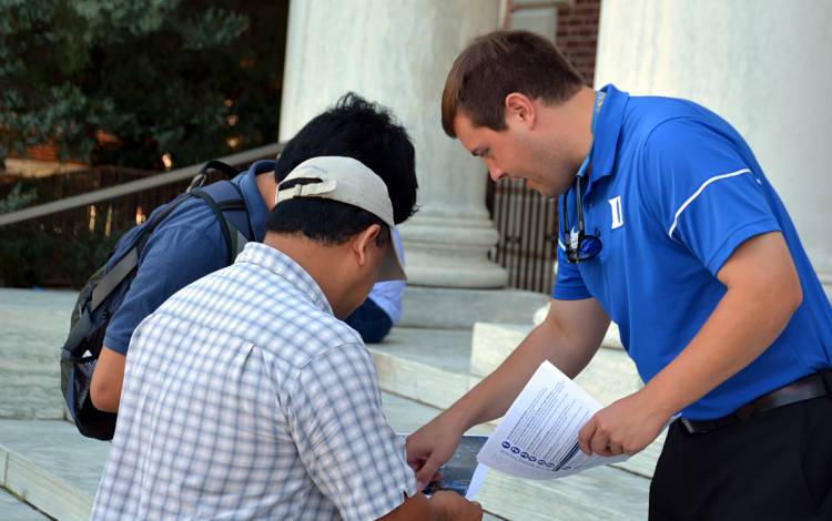 Admissions Officer Adam Tomasiello greets first years and families outside of the East Campus Union, where students picked up their move-in packet, DukeCard and mailbox keys. 