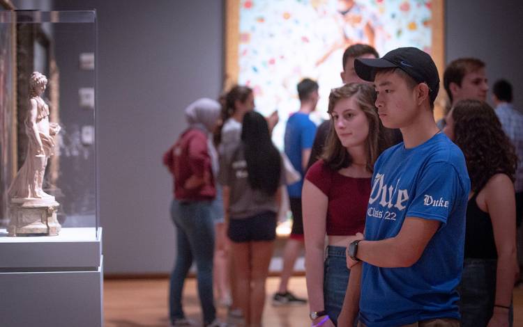 Students looking at a painting.