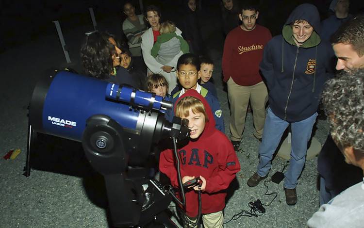 Guests look through a telescope at the Duke Teaching Observatory.