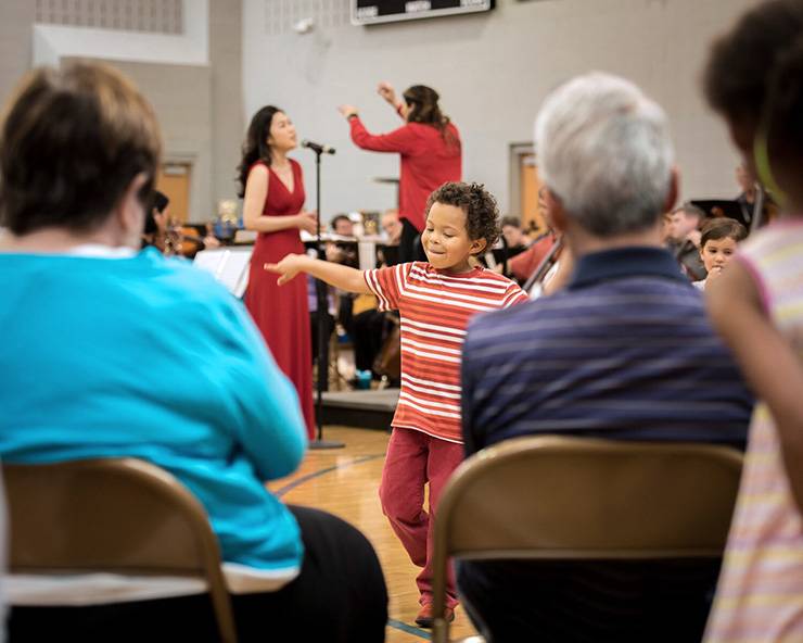 Child dancing to music.