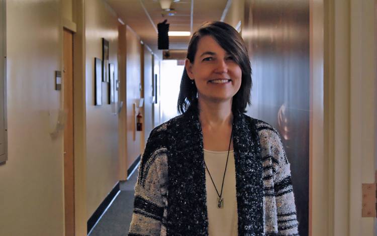  Rae Jean Proeschold-Bell, associate professor at the Duke Global Health Institute, stands on the third floor of Trent Hall, where she once lived as a student and now works.