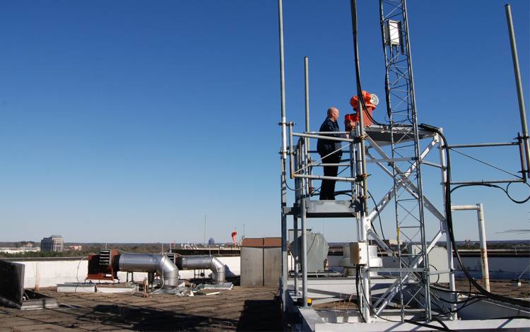 Electrician Bob Moffett check on a beacon near the Duke University Hospital helipad. Photo by Stephen Schramm.