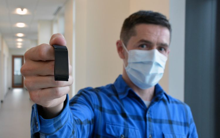 Duke University School of Nursing's Ryan Shaw holds one of the activity monitors used in his research study. Photo by Stephen Schramm.