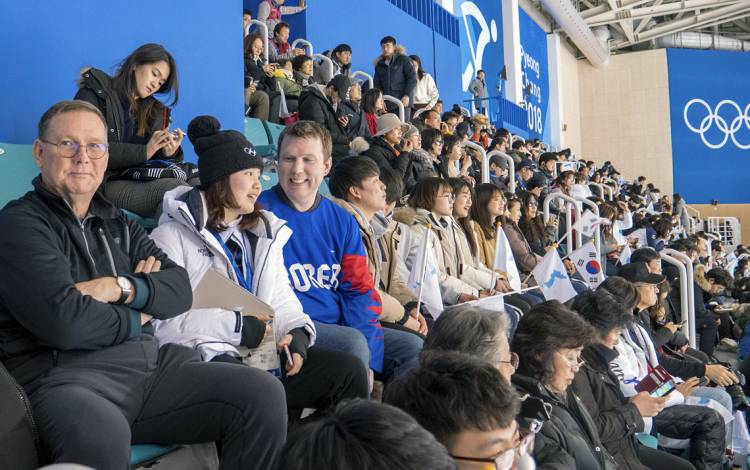 Schuyler Knowles, right, sits with sister Genny Kim Knowles, center, and father Tim Knowles, left.