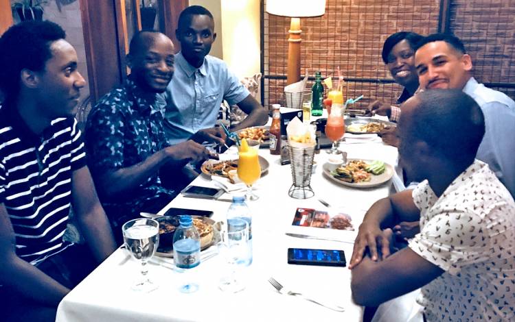 Tony Fuller, middle right, dines with his host family in Uganda. Photo courtesy of Tony Fuller.