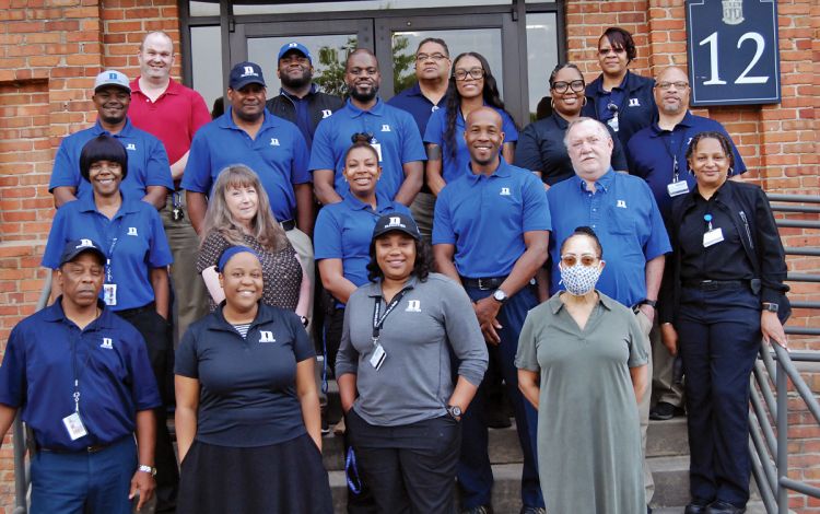 Members of the Duke University Environmental Services leadership and management team gathered outside of Smith Warehouse. Photo by Jack Frederick.