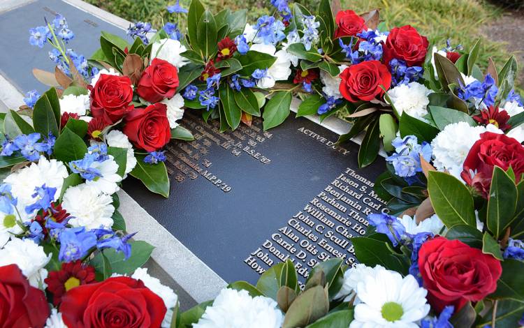 A wreath sits on the Alumni Memorial Wall following the ceremony. Photo by Stephen Schramm.
