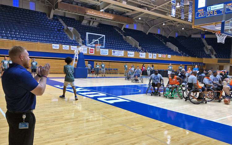 Volunteer Jonathan Braswell watches the wheelchair basketball competition. Photo by Stephen Schramm.