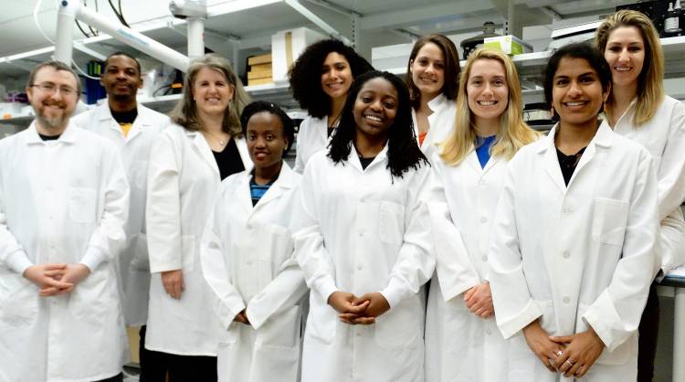 Jennifer West, third from left, stands with students in her lab. 