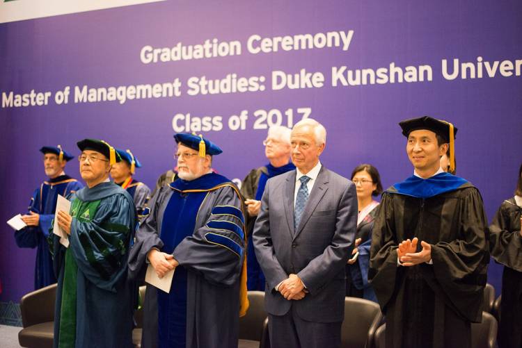 Duke University and Duke Kunshan officials oversee the awarding of degrees.