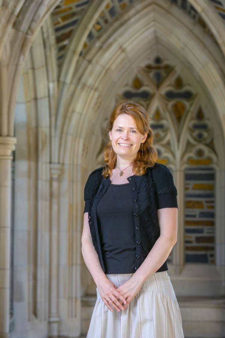 Elizabeth Schrader standing in a hallway outside Duke Chapel
