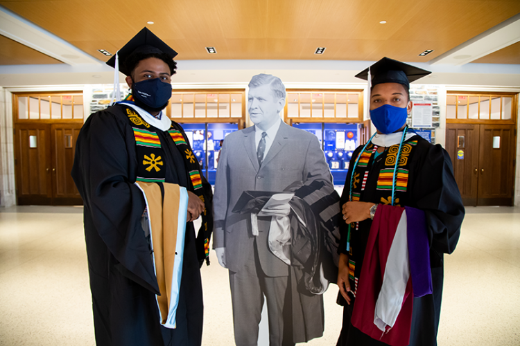 Sanford School graduates pose with cutout of the school's namesake, former N.C. governor and U.S. senator Terry Sanford.