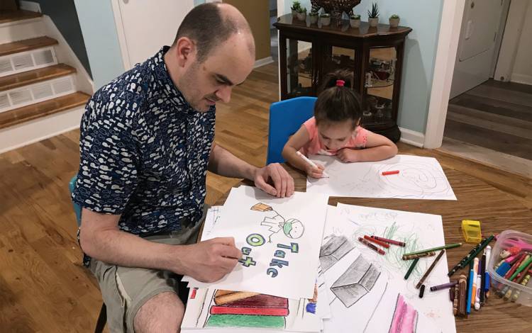 Jamie Keesecker working next to his daughter.