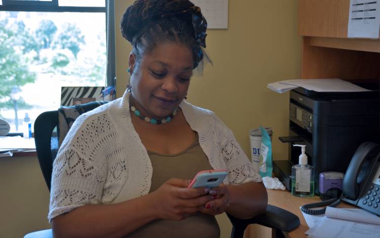 Annette Lancaster uses her phone to communicate with students and colleagues. Photo by Jonathan Black.