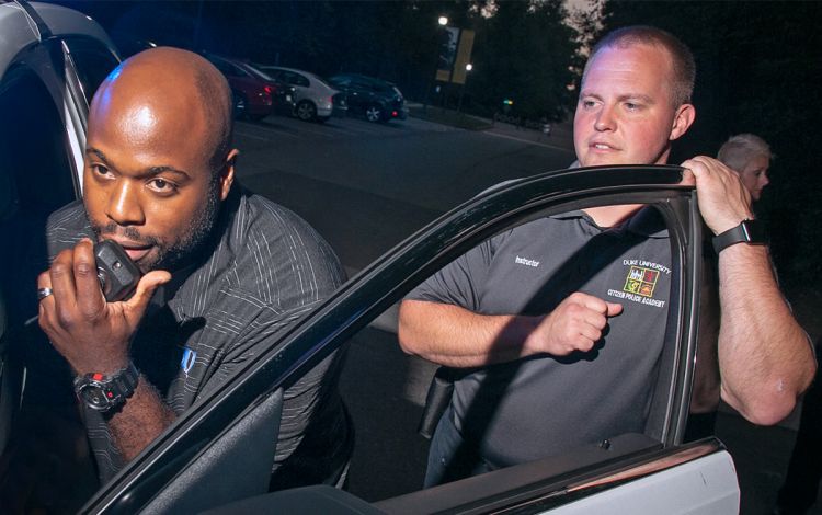 Cortney Hatchell, left, takes part in an exercise during the 2019 Duke Citizens Police Academy as Duke University Police Officer Aaron Pruka watches. Photo by Chris Hildreth.