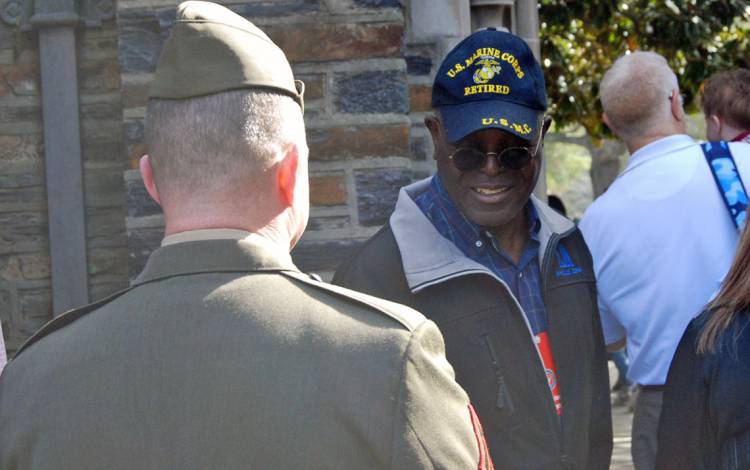 Roland Falana speaks with fellow veterans after Monday's ceremony. Photo by Stephen Schramm.