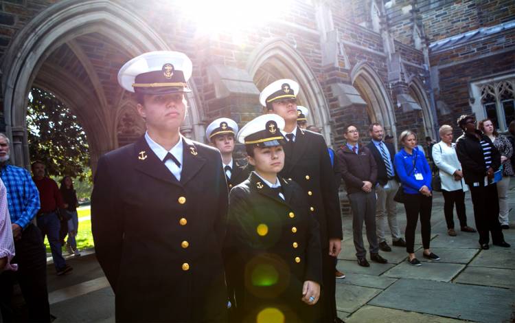 Students, staff and faculty watch a wreath being laid at the Memorial Wall near Duke Chapel. Photo by Jared Lazarus.