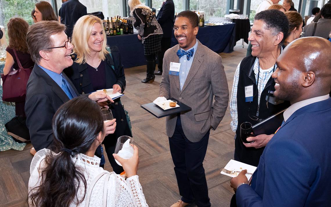 Duke University President Vincent E. Price speaks with guests at the reception following Tuesday's Presidential Awards ceremony. Photo by Les Todd.