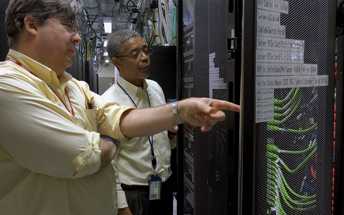 Charley Kneifel, left, with Senior IT Manager, Carl McMillon, in the Duke Data Center in the Telecommunications Building.