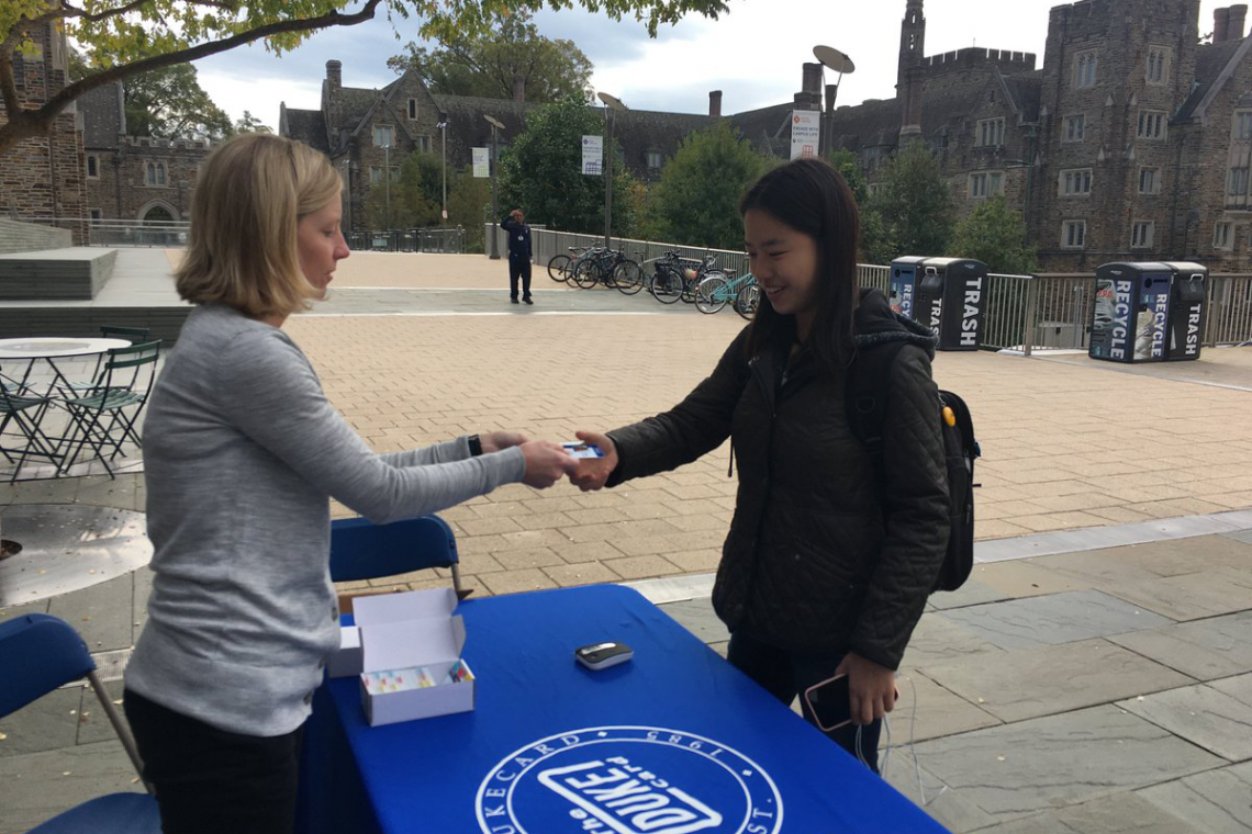 Student Angela Woo is the first to pick up her student voting card, which she can present at the polls today. The POLIS program is coordinating efforts to promote student voting in local elections.