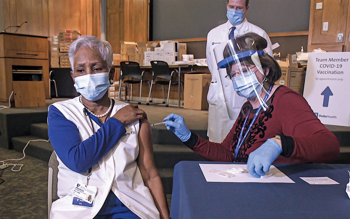 Nursing Program Manager Rita Oakes administers Duke’s first COVID-19 vaccination to Faye Williams on December 14. Photo by Shawn Rocco.