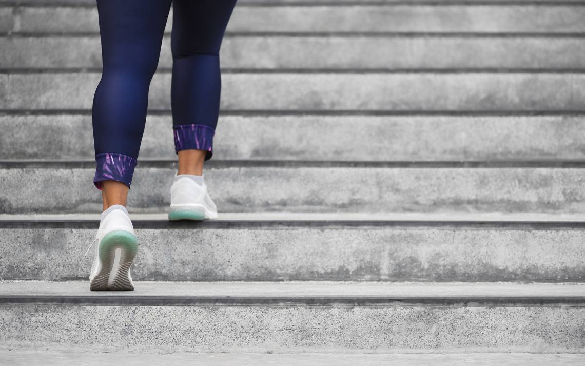 A woman running up stairs.