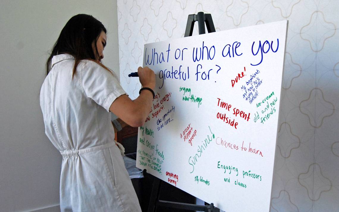 A student writes what she's thankful for during April's Gratitude Lunch, which was organized by Sustainable Duke.