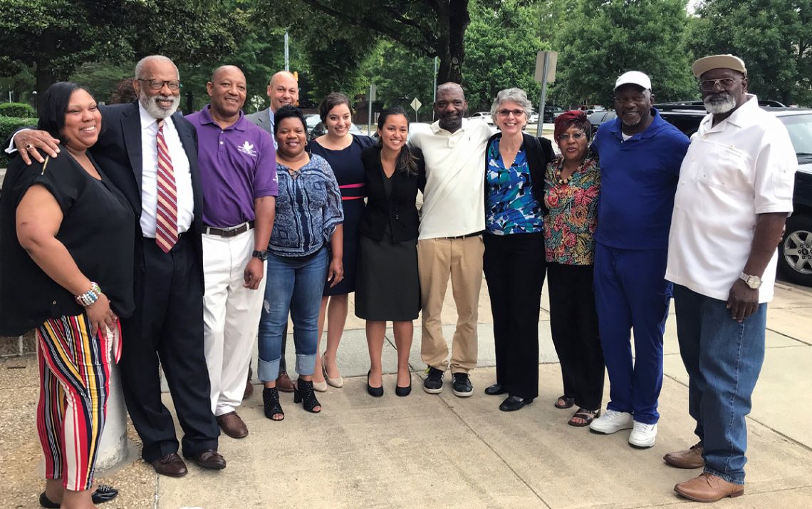 Jim Coleman, second from left, and Jamie Coleman, back row, stand with family members of Charles Ray Finch after he was released from prison in 2019 for a crime he did not commit. Photo courtesy of the Duke Law School.