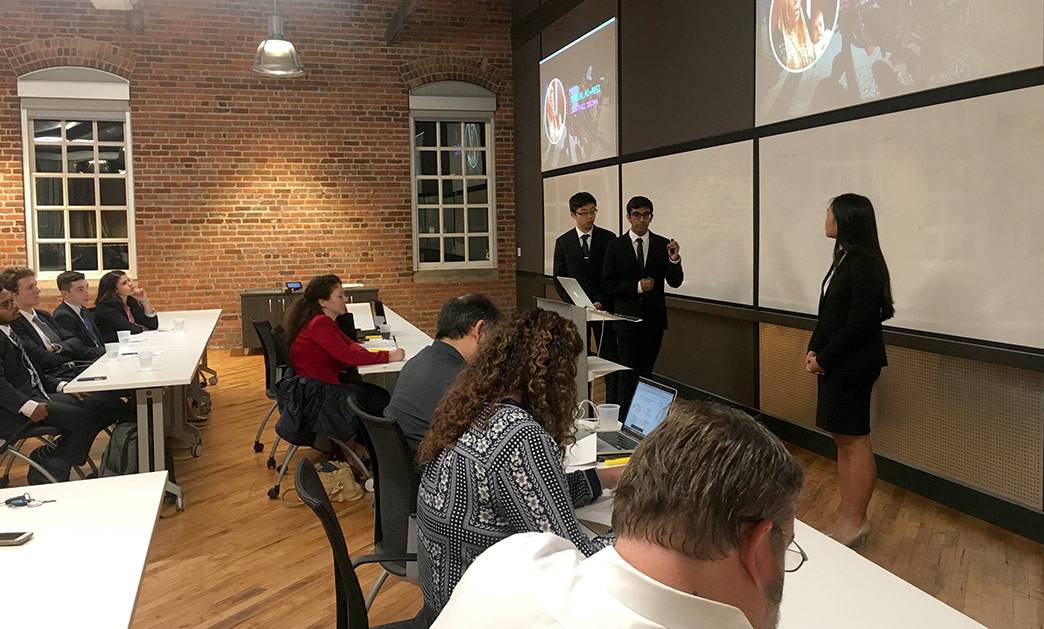 Jason Wang, Saheel Chodavadia and Sherry Feng present their app, Sawiana Enterprises, at the Hult Prize@Duke finals. Photo by Katherine Black