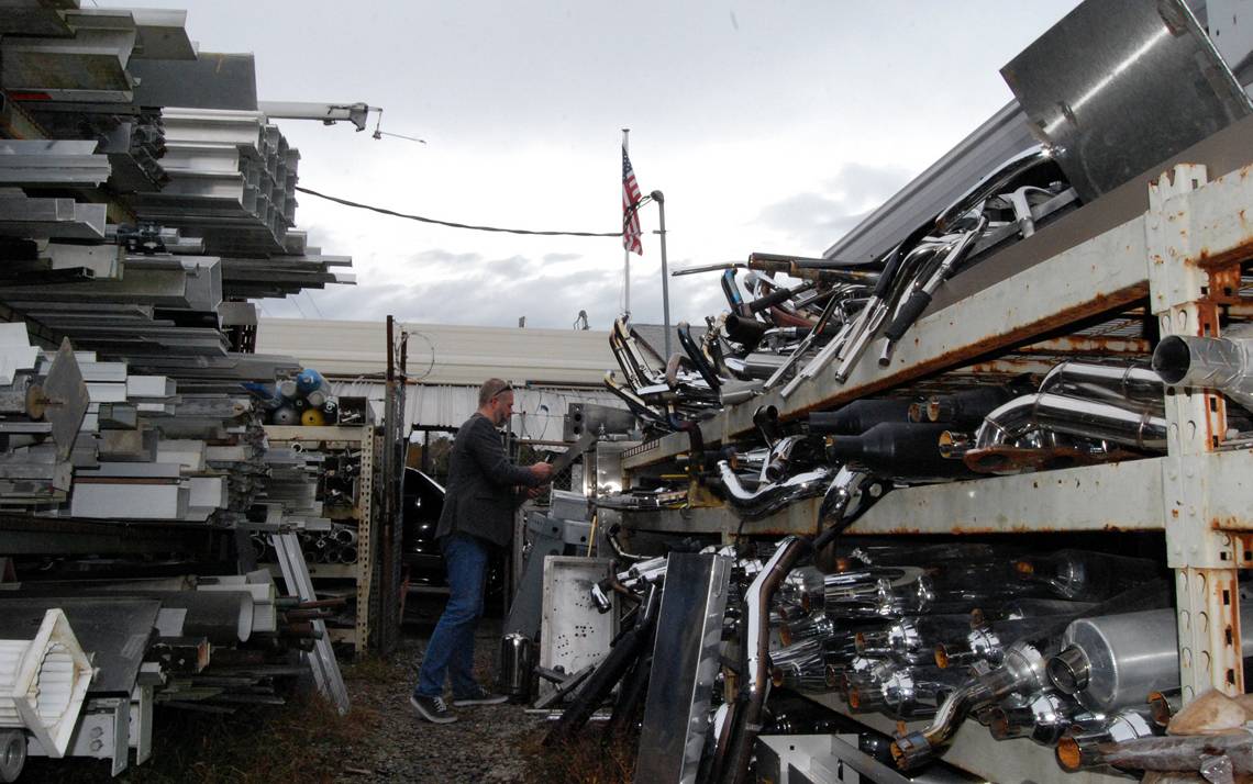 Chip Bobbert, digital media and engineering technologies engineer for Duke’s Office of Information Technology, looks for metal at J & D Recycling. Photo by Stephen Schramm.