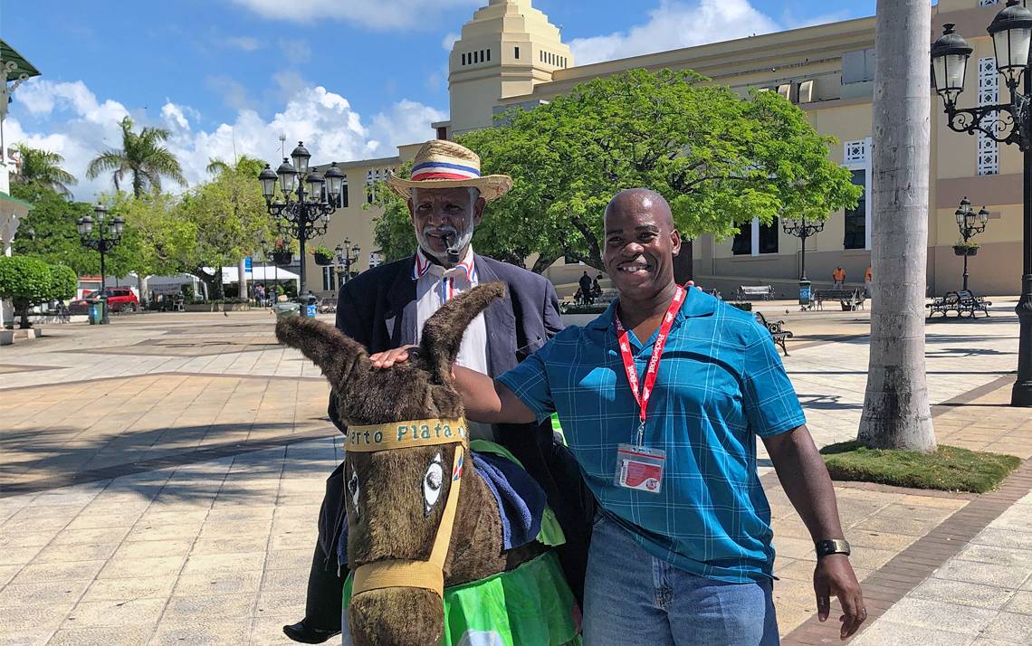 Larry Dublin in a town square with a donkey.
