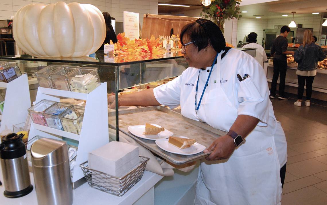 Senior Lead Food Service Worker Georgia Terrell tends to a display of desserts during the Thanksgiving meal at East Campus Marketplace. Photo by Stephen Schramm.