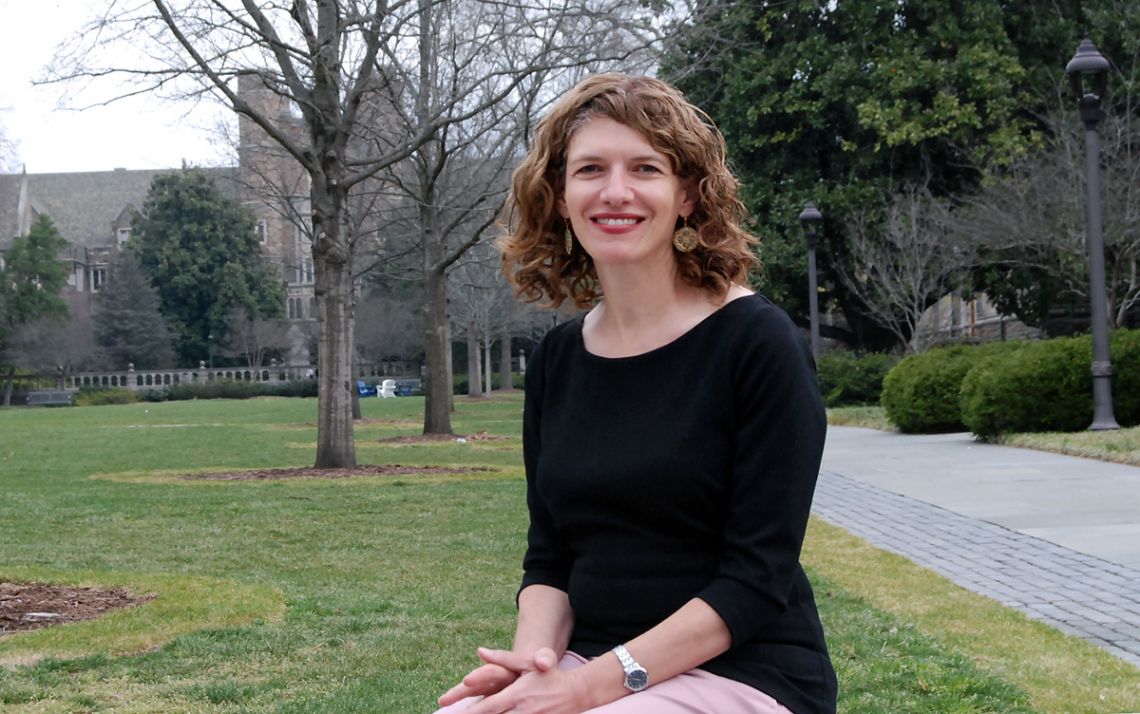 Maria Wisdom, who coaches faculty members and graduate students in her roles at Duke, sits out on the West Campus quad. Photo by Jack Frederick.