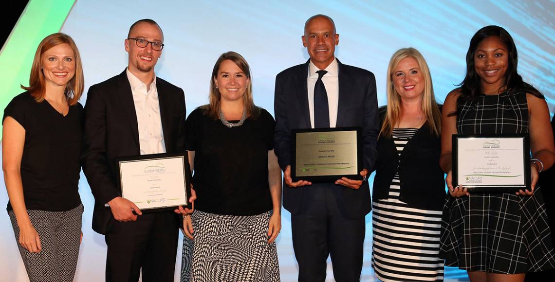 Dawn Hearne, Horton Dining Awards chair, congratulates Duke staff members Marcus Carson, Kirsten Marinko, Robert Coffey, Aris Marton, and Dayla Bonds at the NACUFS ceremony. Photo by Robb Cohen Photography & Video.