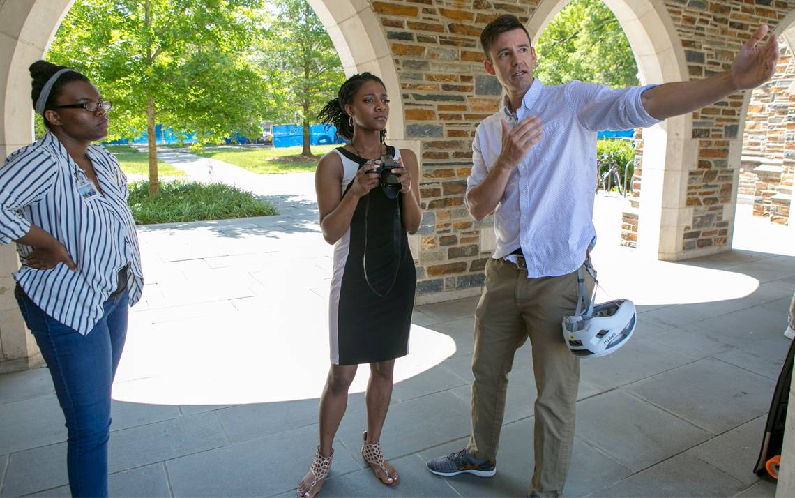 Shaun King, right, multimedia specialist with Political Science, teaches NCCU interns Deja Finch, left, and Cameron Rogers, center, during a photography workshop at the Brodhead Center. Photo by Jared Lazarus.